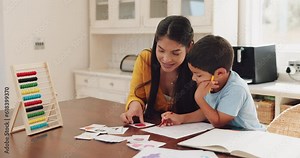 Mother helping her child with homework at their home in the dining room with math flash cards. Learning, education and young woman teaching her boy kid counting with abacus for school in their house.