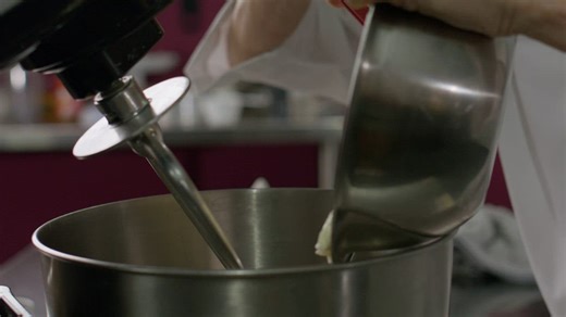 Pastry chef passing a mixture to a blender - Free Stock Video