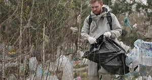 Garbage in forest. Pollution of the environment. People illegally thrown garbage into forest. Illegal garbage and waste in nature. Ecologic problem in not developed countries. man collects garbage in