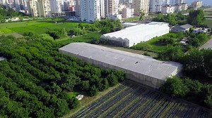 Aerial View of a Farm and Cityscape with Greenhouses | Free Stock Video Footage