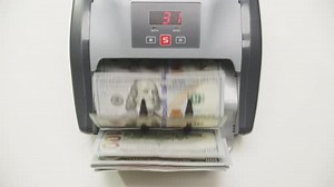 Money Counting Machine Processing US Dollar Bills