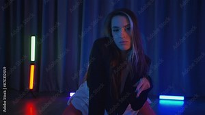 Business woman in white transparent dress erotically dancing twerk and high heels. Half-shaven Girl in red lingerie moving seductively gracefully in darkened space. Striptease in a disco club on stage