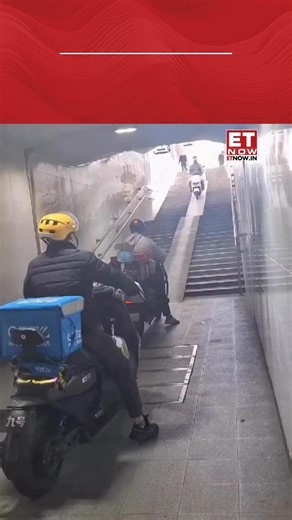 A viral video from a Chinese subway station shows delivery riders carrying their e-scooters up a packed escalator to save time during rush hour. [China subway, delivery riders, e-scooters] #ETTrendingNow | ET NOW