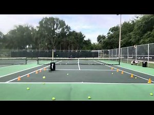 Practicing off the Slinger tennis ball machine, using cones to develop accuracy on my forehand