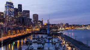Time lapse video of a colorful and vibrant sunrise overlooking the Pier and Ferris Wheel in Downtown Seattle, Washington, United States of America.