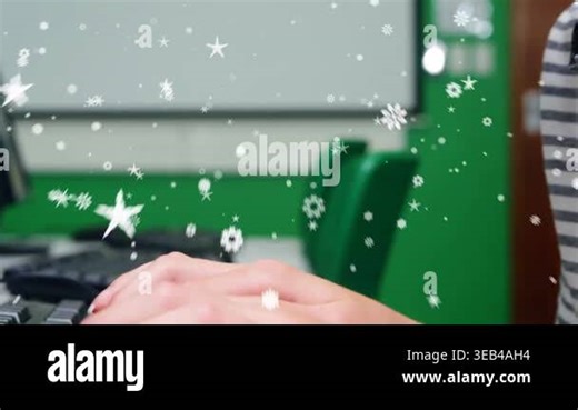 Snowflake and star icons over mid section of caucasian boy using computer in the class at school. School and education concept Stock Video Footage - Alamy