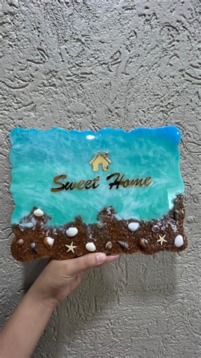 Scribbles Atelier on Instagram: "We crafted this ocean-inspired resin nameplate for one of our lovely clients 🌊 To achieve a realistic 3D depth, we layered natural shells, beach sand, and premium resin Finished with a high-gloss top coat for that clean, luxe look ✨ ▪️ Size: 8 × 12 inches Want a nameplate that truly reflects your vibe? We customise designs in any theme of your choice 🏡⚡ 📍 Based in Gujarat 📞 Calling hours: 11 AM – 6 PM #resinnameplate #oceanresin #customnameplate #handmadeingu