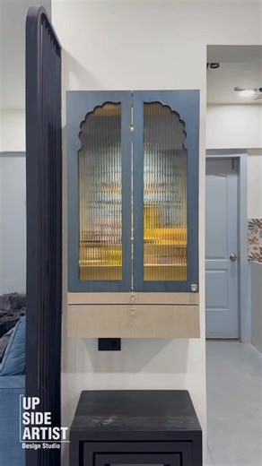 Upside Artist Design Studio on Instagram: "Designed as a focal niche within the living space, this mandir unit balances proportion, texture, and visual harmony. The arched hand-painted backdrop adds depth and character, while the neutral cabinetry keeps the composition light and contemporary. Subtle lighting highlights the artwork and creates a calm visual anchor without overwhelming the room. Designed For: @ravneet2416 Photo: @studioinnex Styling: @stagedhomes_bystudioinnex . . . . . . . . . #U