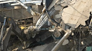 Building demolition. A huge machine arm destroys the house. Dust, debris, bricks, shards fly down. Recorded in slow motion.,