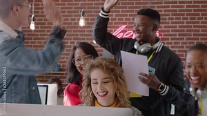 happy business people celebrating victory cheering excited enjoying watching entertainment on computer screen excited colleagues high five spontaneous celebration in office workplace