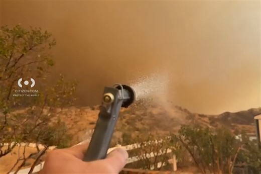 Homeowner waters property as Hughes Fire approaches