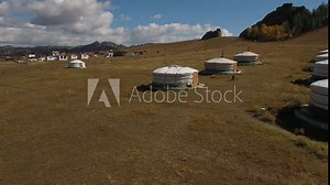 Park Terelj rocks and steppe near Ulaanbaatar Mongolia. Summer autumn sunny blue sky clouds. Beautiful Mongolian nature. Aerial drone forwatd movement to yurts tents village