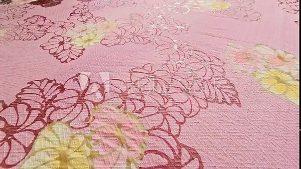 Making batik by drawing freehand patterns on fabric in Thailand.