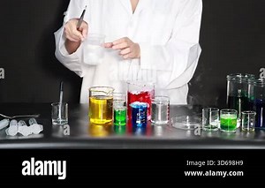 Scientist conducts experiment with colorful liquids