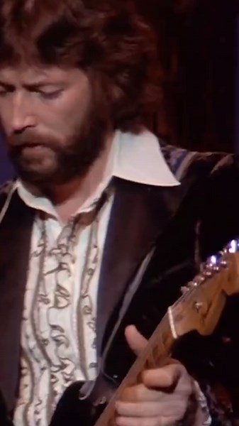 Eric Clapton and Robbie Robertson of The Band trading guitar solos in “Further On Up The Road” following Clapton’s guitar strap difficulties (1976).