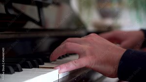 Male Pianist playing on a beautifully rustic old piano, student playing piano with close up keys. Close up frame to the left.