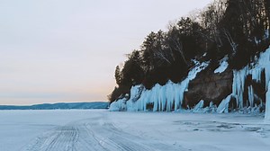 Reaching a magnificent ice cave in Michigan’s Upper Peninsula requires traversing an ice bridge on Lake Superior. Live the adventure. | Merrell