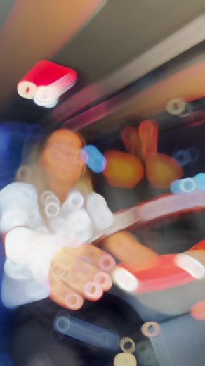 Woman Driving a Bus Through Urban Scenery