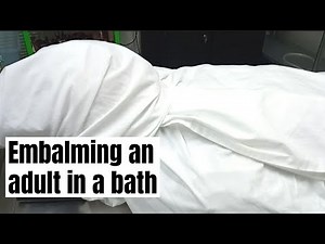 Embalming an adult in a bath