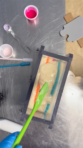 The August Soap Challenge is here and the theme is Comic Cake Soap! 🎂✨ I wanted to push my skills with this one, so I combined so many techniques—layering, soap scraping, extruding soap dough, and even piping on top to give it that frosted cake look. 🍒 I used Caprica Soapery’s @capricasoapery spreadsheet to help me calculate the layers (a total lifesaver!), a recipe from Lovin Soap @lovinsoapstudio for the soap dough, and tools like my clay extruder, templates from Michaels, and a mold from Cu