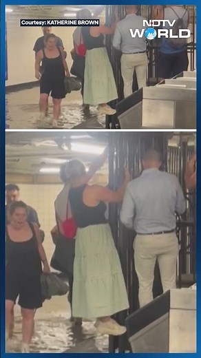 New York: Subway Passengers Walk In Flood Waters In New York Train Station