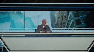 Comical funny Caucasian male anchorman reporting on a story in live news studio. Television newsroom channel with professional anchor presenter