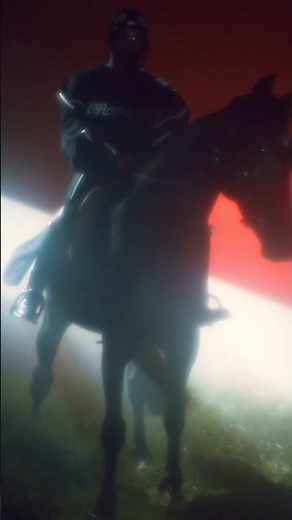 full body man with black outfit sitting a black horse