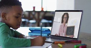 clip-1073048432-african-american-boy-sitting-desk-using-laptop