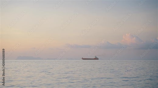 Ship sailing in the sea at sunset. Large cargo ship or industrial vessel, concept of global logistics and trade