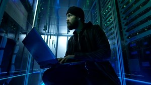 Stock Video Hacker Sitting On The Ground Of Data Center Live Wallpaper For PC