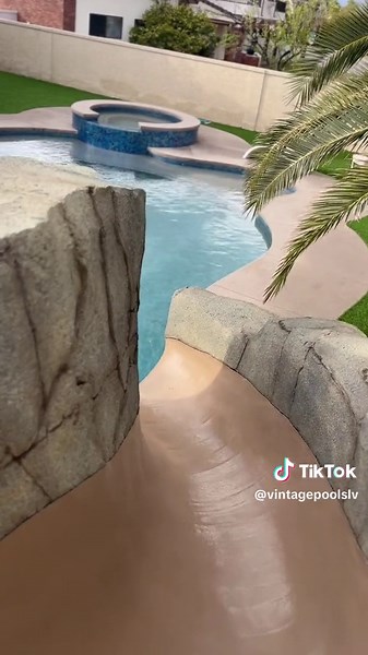 BEFORE ➡️ AFTER⠀ ⠀ For this 770 sq ft and 54 sq ft spa remodel, we ripped up the whole existing pool 😱⠀ We added a rock formation slide, grotto, and water features.⠀ We also installed the ground trampoline!⠀ ⠀ Call us at 702.433.2700 for your FREE consultation to build your dream pool 🌊⠀ ⠀ #VintagePoolsLV #VegasPools #CustomPools #PoolConstruction #PoolLife #Water #Paradise #Swimming #PoolTransformation