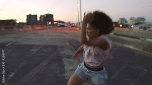 Trendy freestyle dancer practicing choreography in a city. Modern, funky and edgy young woman dancing with powerful contemporary movement. Performing with cool attitude, expressive swaying and rhythm