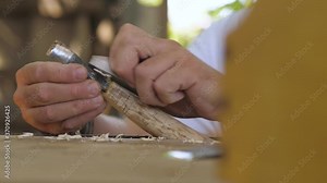 a carpenter planes a wooden handle for a chisel with a small plane. fhd. 24 fps
