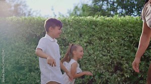 Parents with children playing blind man buff. Man eyes tied with blindfold