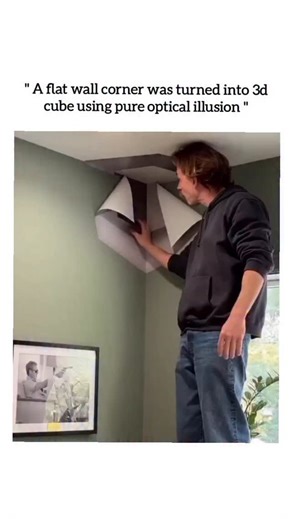 UNIVERSAL REEL HUB on Instagram: "This viral reel features a captivating trompe-l’œil anamorphic illusion where an artist transforms a flat corner wall into a seemingly 3D floating cube through the mastery of forced perspective and strategic shading. The video showcases the final stages of the process, with the artist peeling back protective tape to reveal a geometric design that appears to carve a deep, hollowed-out void into the architecture of the room. As the camera moves, the viewer witness