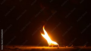Hexamine Fuel Tablet is Burning on the Ground Bright Flames on Black Background Yellow Fire in the Evening High Temperature Ancient Lighting