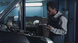 Mechanic checking a car motor - Free Stock Video