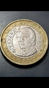 This beautiful Spanish 1 Euro coin from 2004 is a must-have for any coin collector or Euro enthusiast. On the obverse (front), it features a detailed portrait of King Juan Carlos I, who reigned over Spain from 1975 to 2014, symbolizing Spain’s modern monarchy and history. The reverse (back) shows the standard Eurozone map design, connecting Spain with the rest of Europe through the shared currency. The coin is bimetallic, with a silver-colored center and a gold-colored outer ring, giving it a di