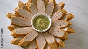 fried Chinese fish cake or fish ball line sliced with spicy seafood dipping sauce