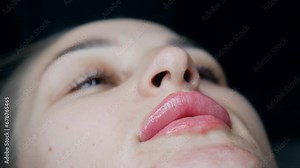 lip augmentation procedure. female lips. Male surgeon injectionist carefully and slowly injects hyaluronic acid into woman's lips with a syringe. beauty injections. Plastic surgery.