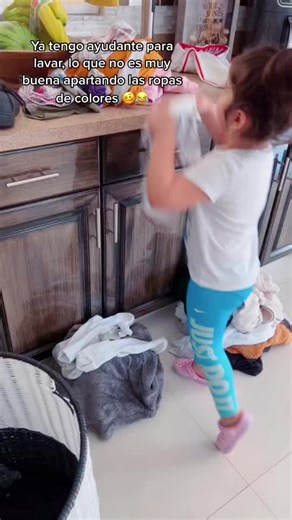 Adorable Child Sorts Laundry with a Smile