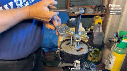 The proper technique when using tools is essential. Here's how to use a light but powerful three-legged puller—needed to safely remove a seized flywheel from an outboard engine without causing damage or injury | Practical Boat Owner