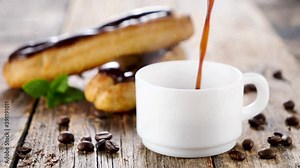 coffee drink pouring in a cup and chocolate eclair background