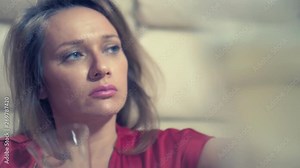 woman gets drunk at home alone at a table set for two for a romantic date, as her partner did not come on a date