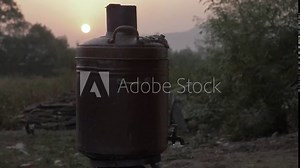 Static handheld shot of vintage copper coal fired water heater boiler heating water early morning during winters in the village