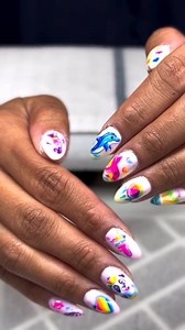 Sorry not sorry, but the Lisa Frank nails have us in a chokehold 🐬💅 Which one’s your fave? Summer slay courtesy of the ever-talented @melaniezamoranails 😍✨ | Sola Salons