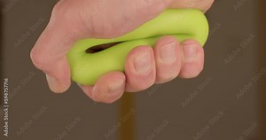 Active arm muscle training after using the computer. Squeezing and squeezing the rubber ring with your fingers. Activation of the blood circulation of the limb. Generative AI