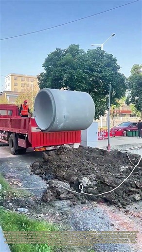 Tug of Unload: The Excavator's Finesse with Concrete Pipes