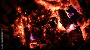 Footage of with glowing embers and glow of burning wood and the radiant warmth. Glowing fire with embers and burning flames