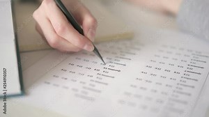 Close up of blank with multiple choice quiz. Close up of hand painting a cell with a answers in multiple-choice questions. Student fills in answers in multiple choice test
